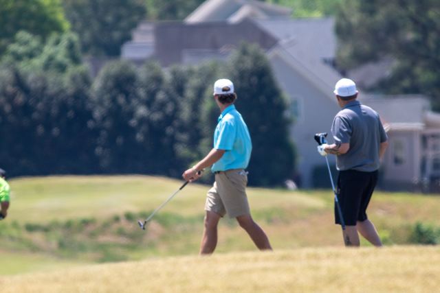 Players lining up a putt on the green